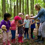 Educator Katie Pollock takes her class outside to experience the textures and smells of plants growing at one of the edible forest garden sites.