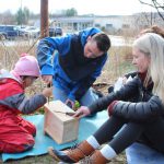 A child works on a birdhouse as part of a program in which College of Education and Human Development students and faculty collaborate with College of Engineering students and faculty to help children learn about birds.