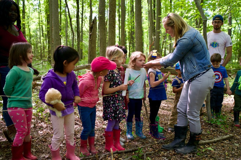 Educator Katie Pollock takes her class outside to experience the textures and smells of plants growing at one of the edible forest garden sites.