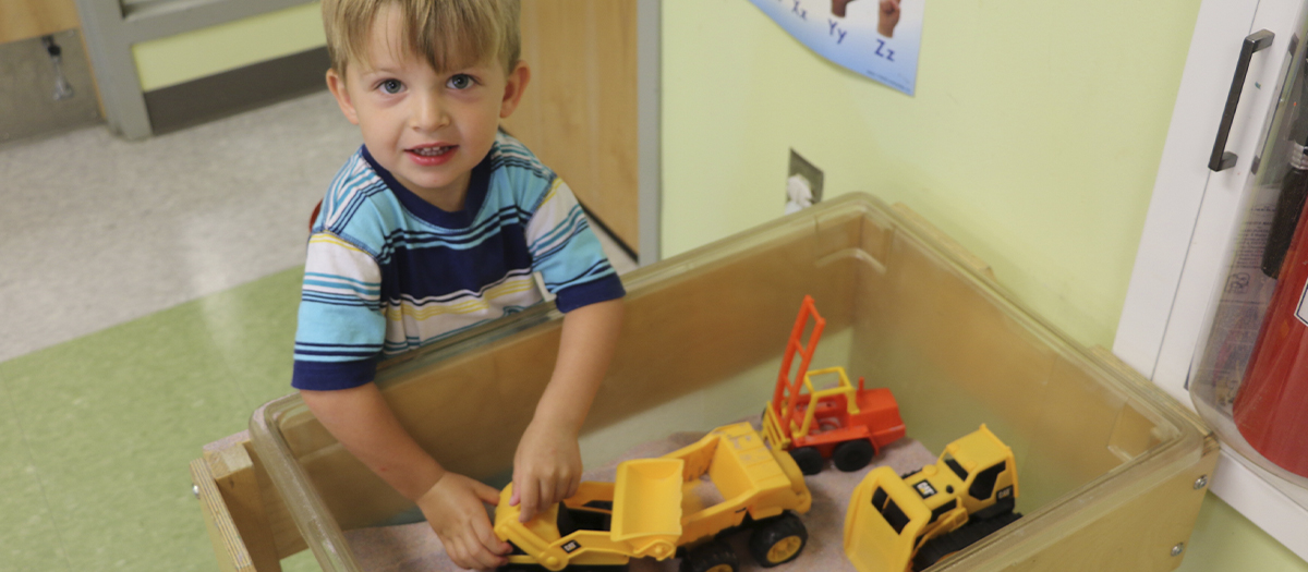 Child plays with toy truck at the UD Lab School