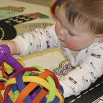 Baby playing with toy at UD Lab School