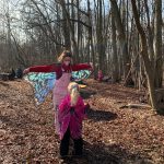 A preschooler learns about butterflies with a UD student outside at CEHD's Lab School.