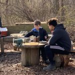 A University of Delaware student and a child interact in the Lab’s School’s outdoor mud kitchen, located on the College of Education and Human Development’s Children’s Campus.